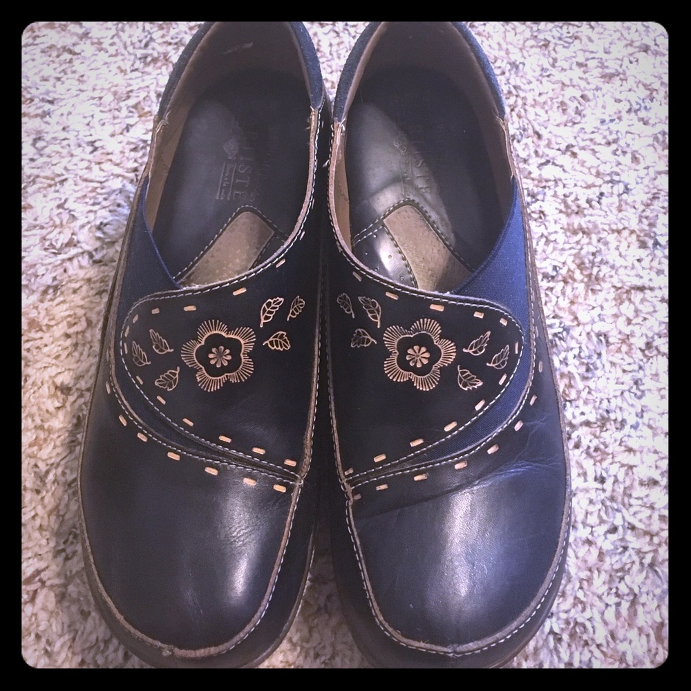Size 8 leather clogs with tooling.